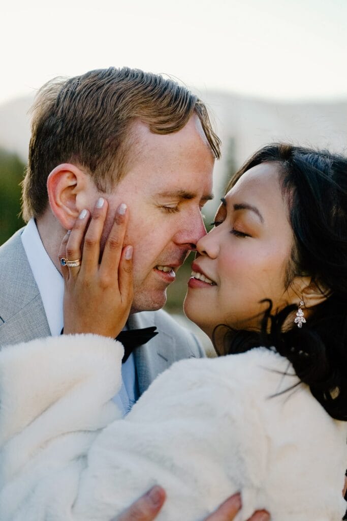 close-up of bride and grooms faces with their eyes closed during their self-solemnization ceremony during their breckenridge elopement in colorado