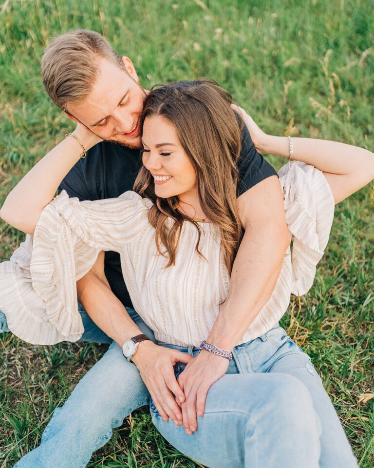 adorable couple sitting in the grass at chautauqua park during their boulder colorado couples session