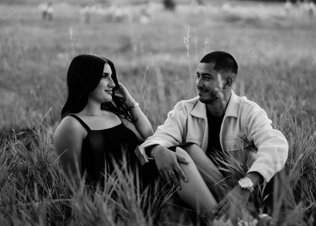 A cpuple looks at eachother adoringly at their engagement session at Lost Gulch Overlook, CO