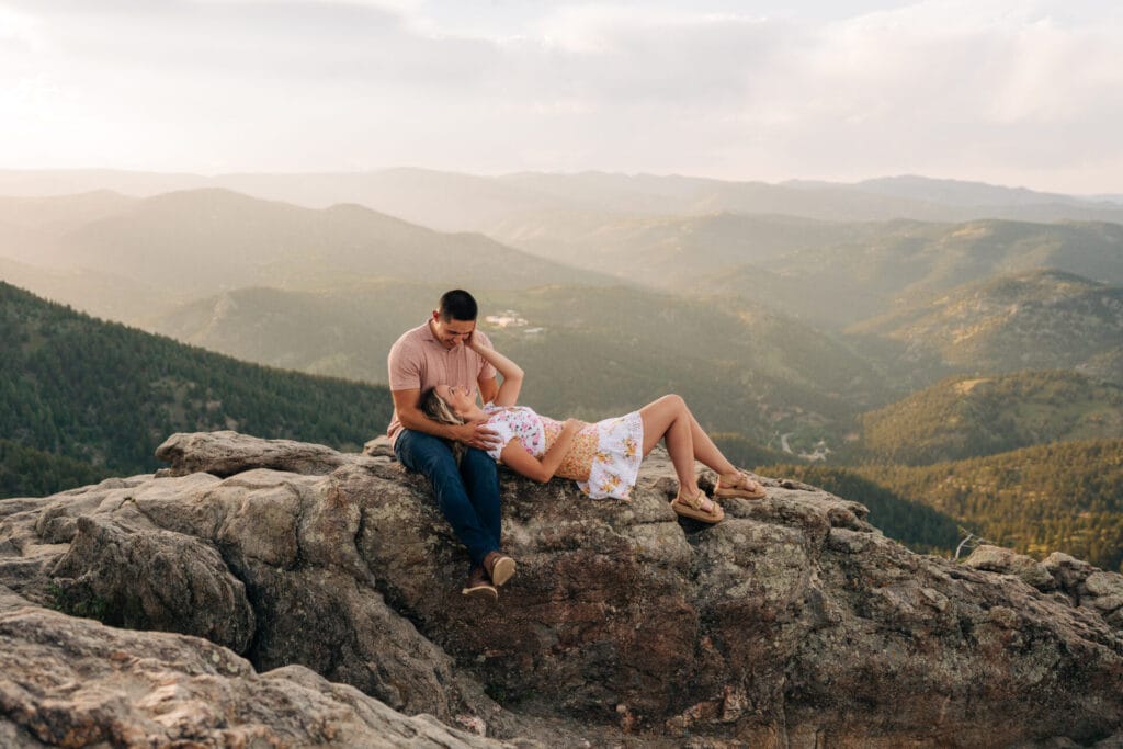 girlfriend laying on boiyfriends lap on a cliff at Lost gulch overlook in boulder, colorado