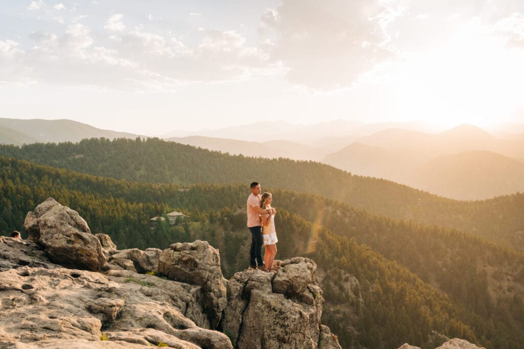 boyfriend hugging his girlfriend from behind on a cliff at Lost Gulch Overlook in Boulder, Colorado