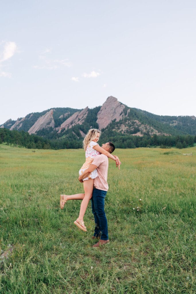 Couple embracing in lush mountain landscape