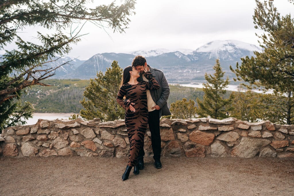 Chelsea and Eric holding eachother during their engagement photos at Sapphire Point Overlook in Breckenridge, CO