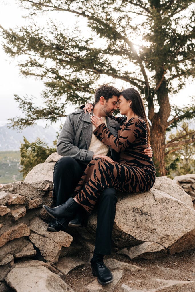Chelsea and Eric sitting on the rocks at Sapphire Point Overlook in Breckenridge, CO