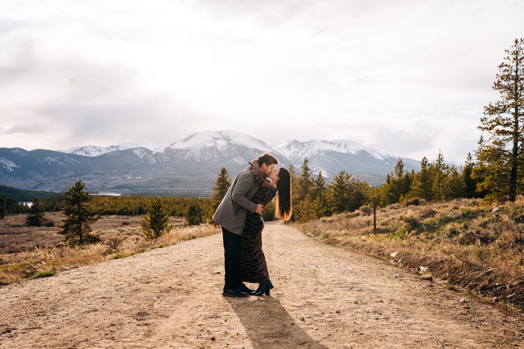 Eric kissing Chelsea and dipping her during their proposal photos at Sapphire Point Overlook in Breckenridge, Colorado