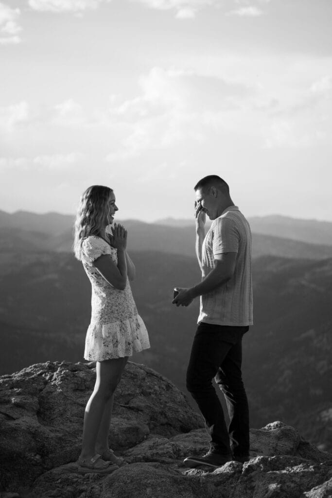Austin wiping his eyes after proposing to his girl friend on a cliff at Lost Gulch Overlook in Boulder, Colorado