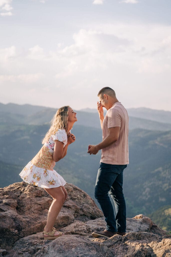 Boyfriend wiping his eyes after crying during his proposal to his girlfriend at Lost Gulch Overlook in Boulder Colorado