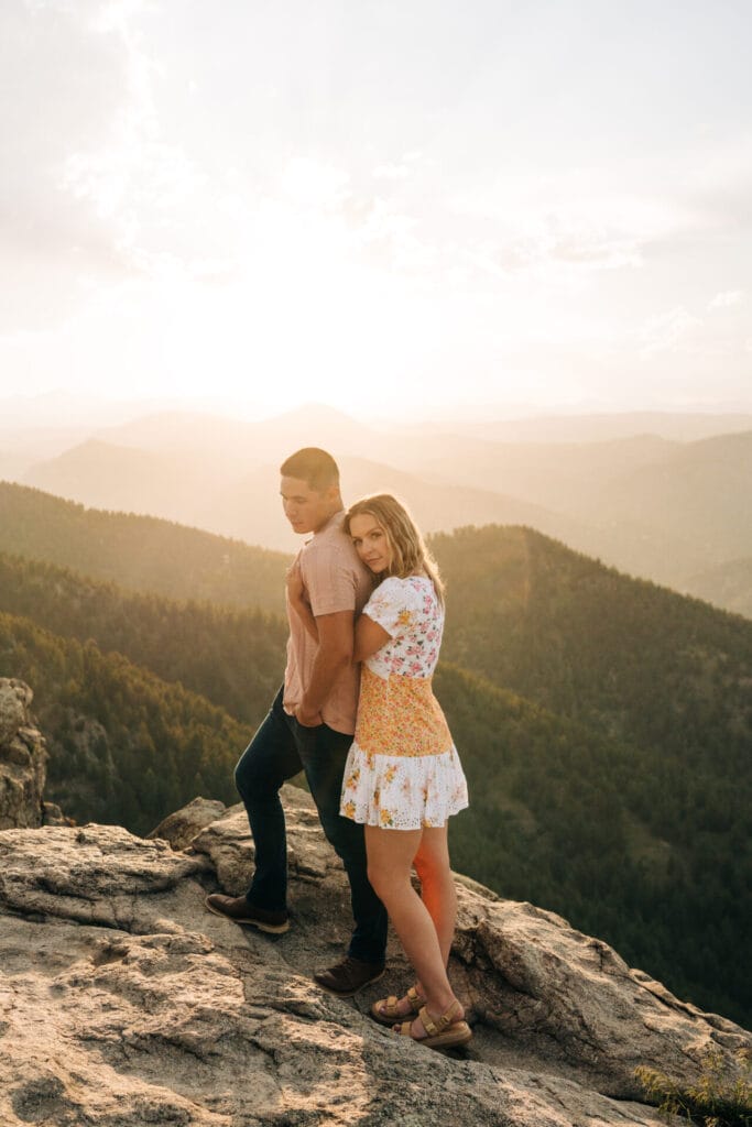 girlfriend hugging boyfriend behind at Lost gulch overlook in boulder, colorado