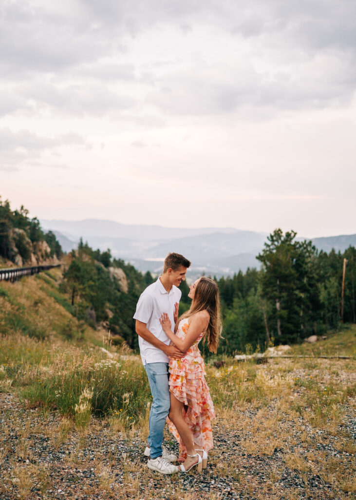 girlfriend smiling up at her boyfriend during their lily lake engagement photos