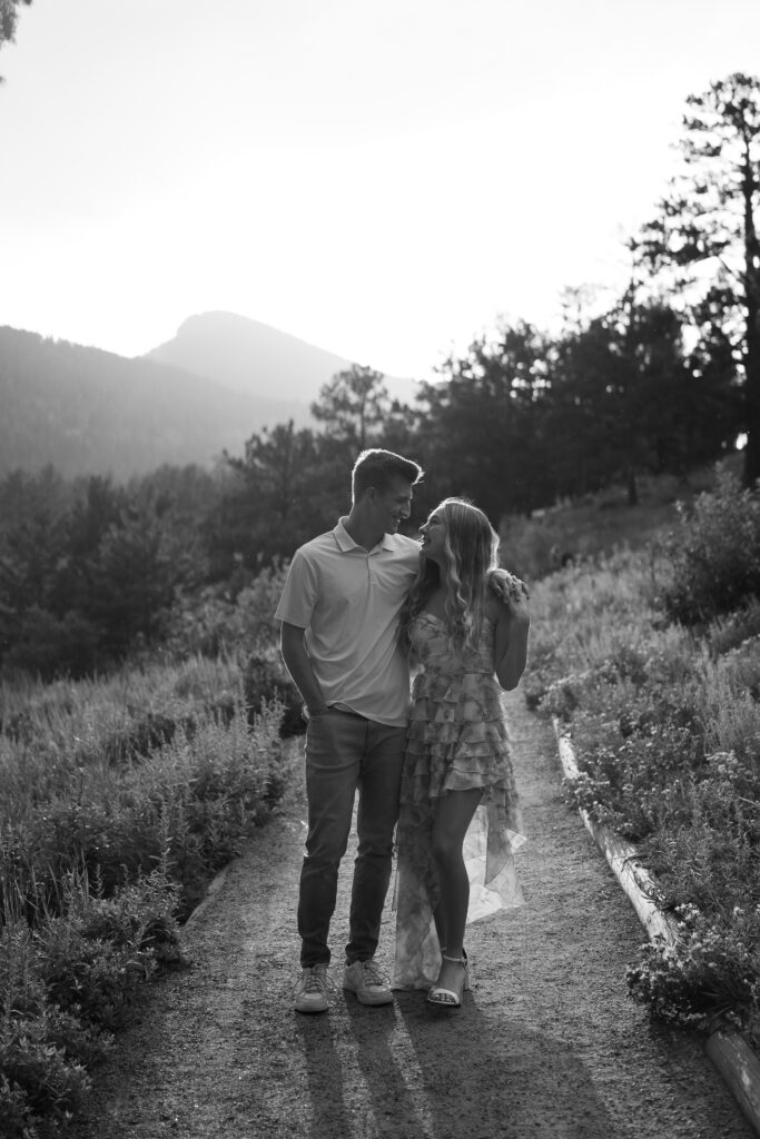 cute couple walking down a path holding hands during their lily lake engagement photos