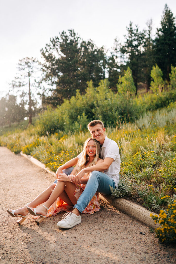 sweet young couple smiling and hugging during their lily engagement photos