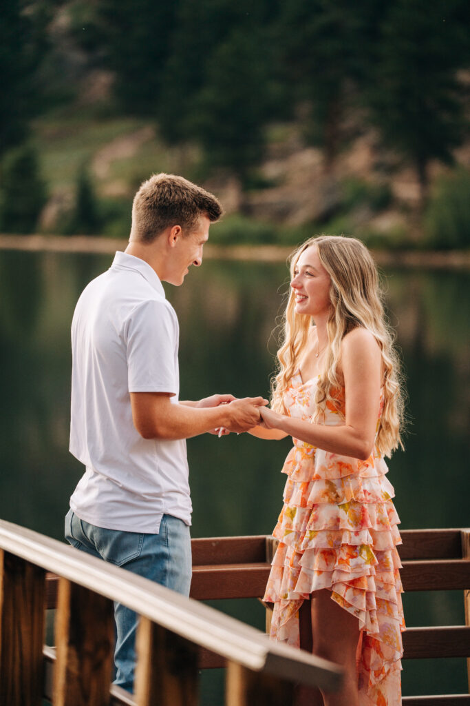 girlfriend looking at her boyfriend during their proposal at Lily Lake near estes park