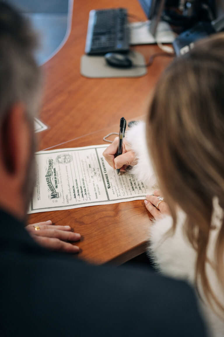 bride and groom signing marriage license in Breckenridge