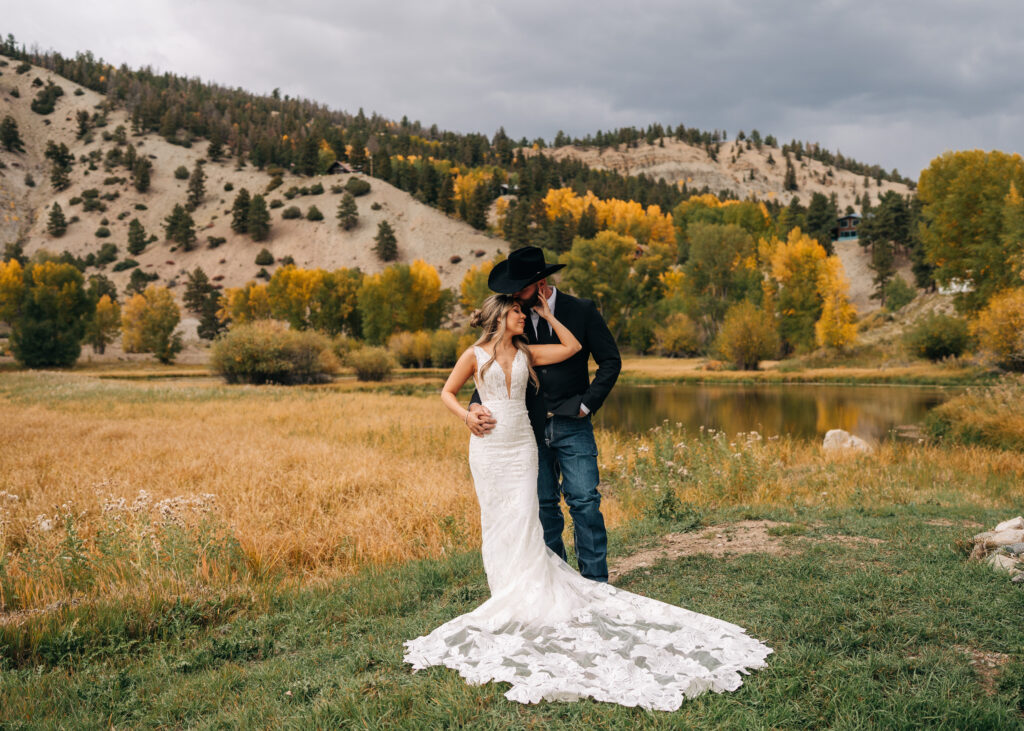 bride caressing grooms face during their bride and groom portraits during their lake city colorado elopement