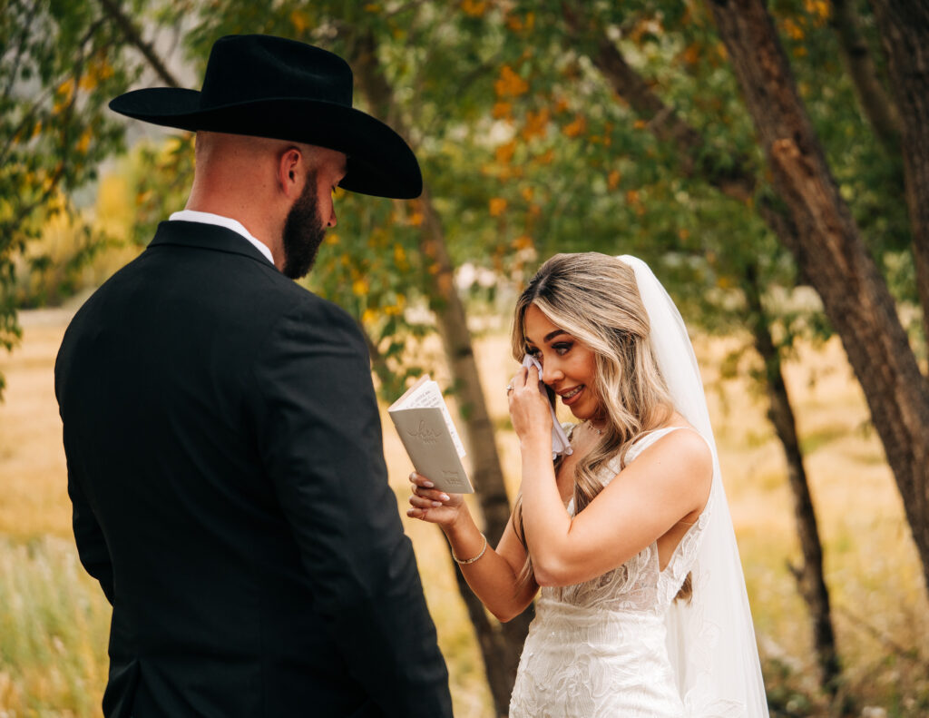 bride crying as she reads her vows to the groom during their lake city colorado elopement