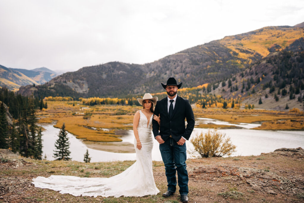 bride holding onto grooms arm during their lake city colorado elopement photos