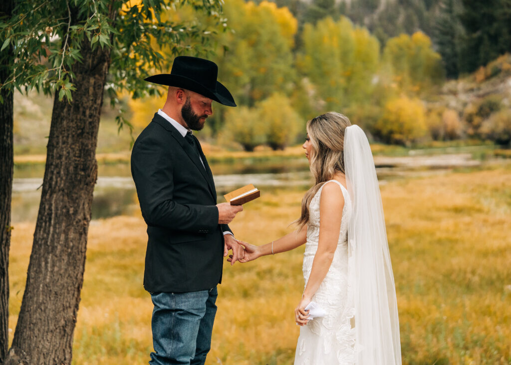 groom reading his vows to bride during their elopement in lake city colorado