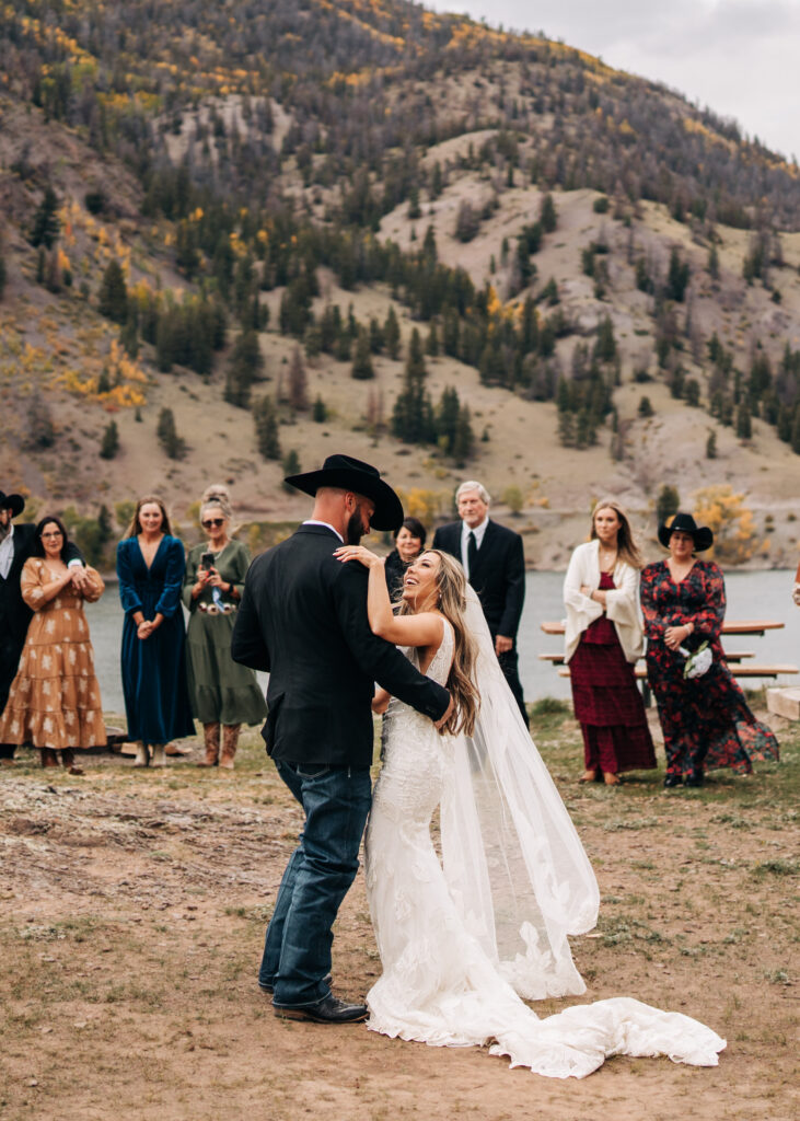 bride and groom laughing and dancing during their lake city colorado elopement