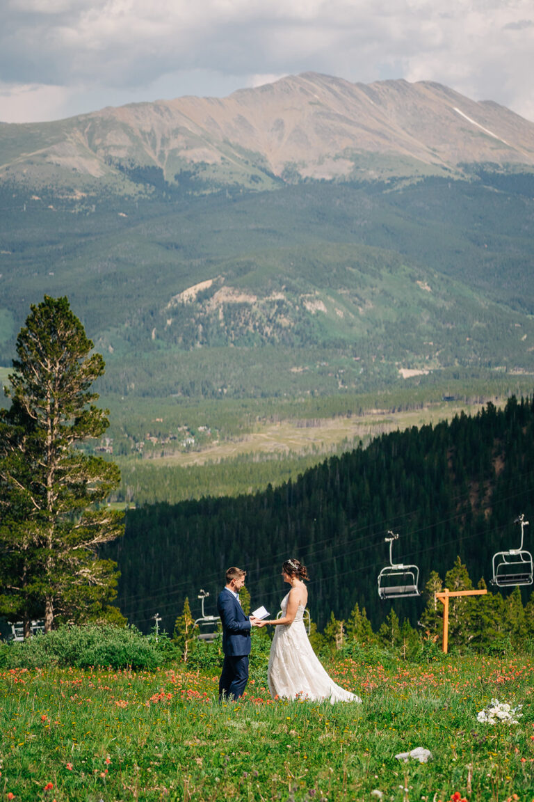 Couple exchanging vows in mountains.