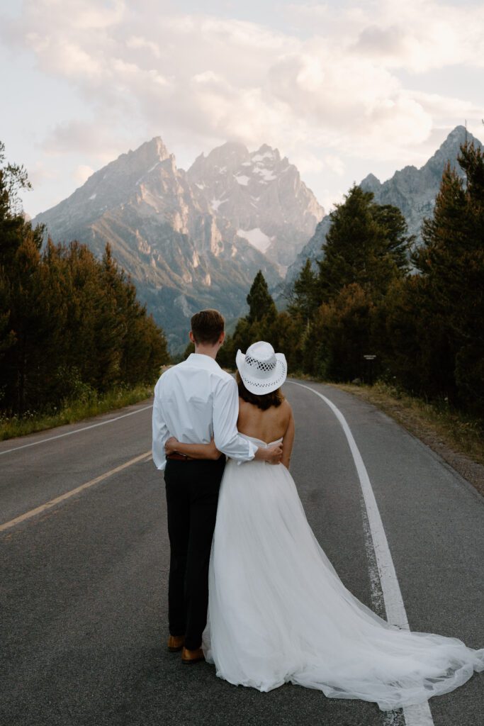 bride and groom looking at the mountains together in grand teton national park during their elopement