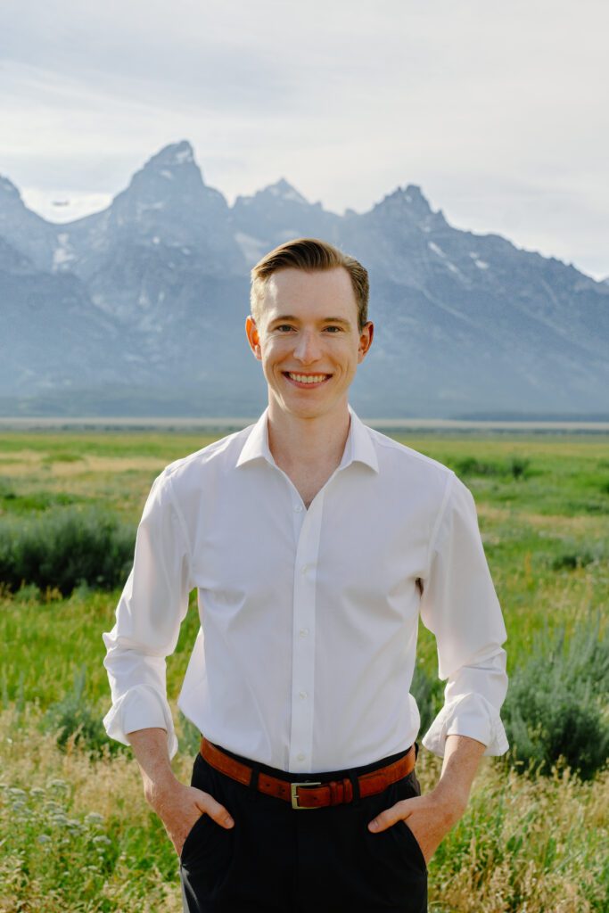 portrait of groom in front of the grand tetons during his elopement portraits