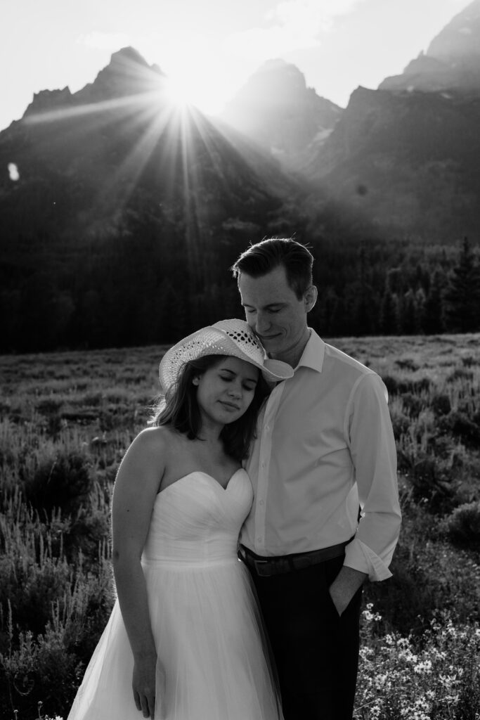 groom and bride snuggled up at grand teton national park during their wyoming elopement
