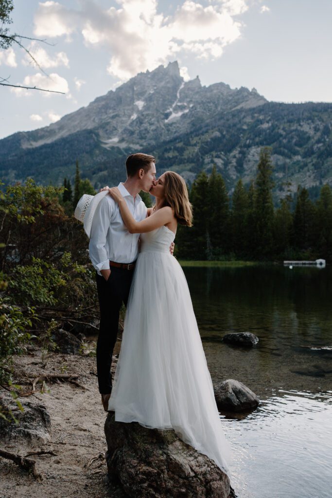 bride and groom kissing at Jenny Lake in Grand Teton National Park during their wyoming elopement