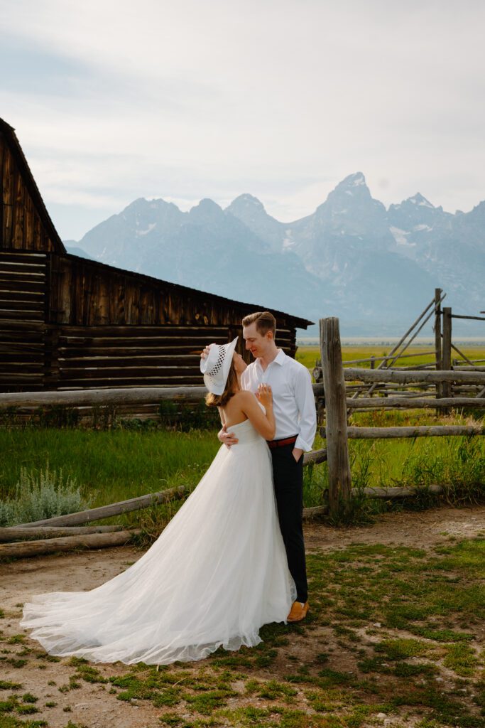 elopement portraits at mormon with bride and groom wearing wedding attire and kissing in grand teton national park