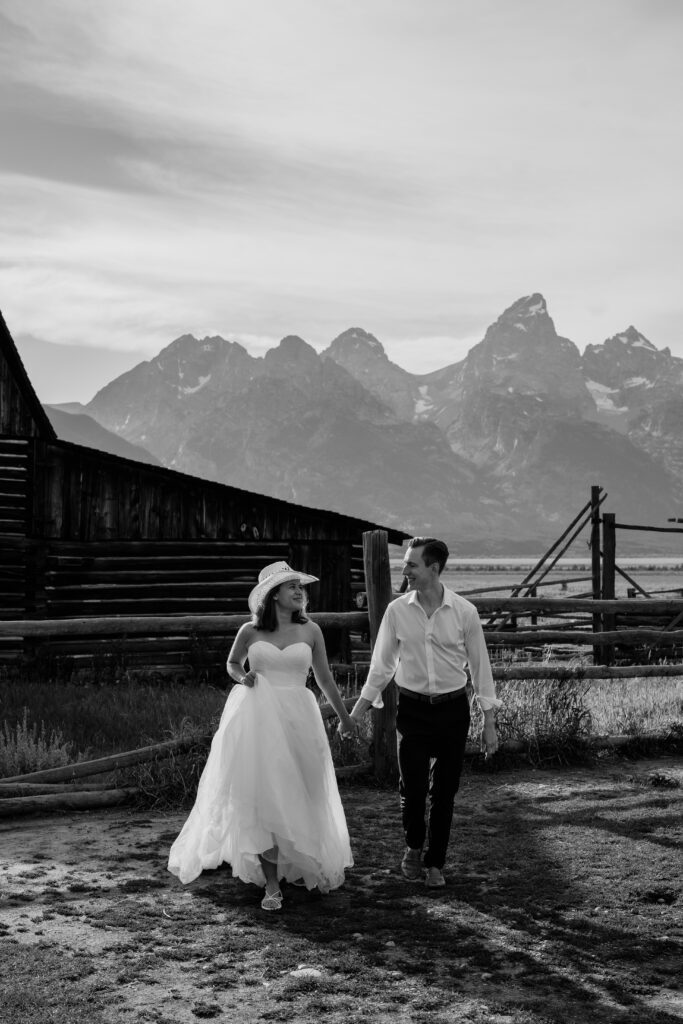 bride and groom running towards the camera at mormon row during their grand teton elopement