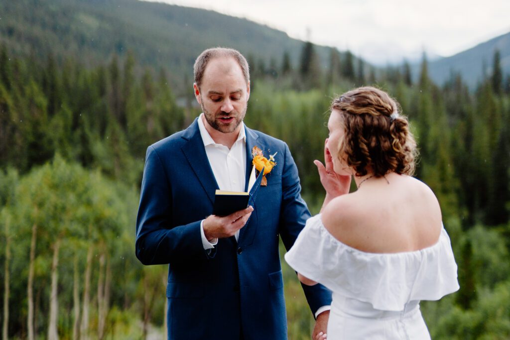 groom reading his vows to his bride during their eldora mountain colorado elopement 