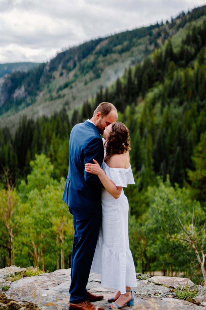 bride and groom sharing their first kiss during their eldora mountain colorado elopement ceremony