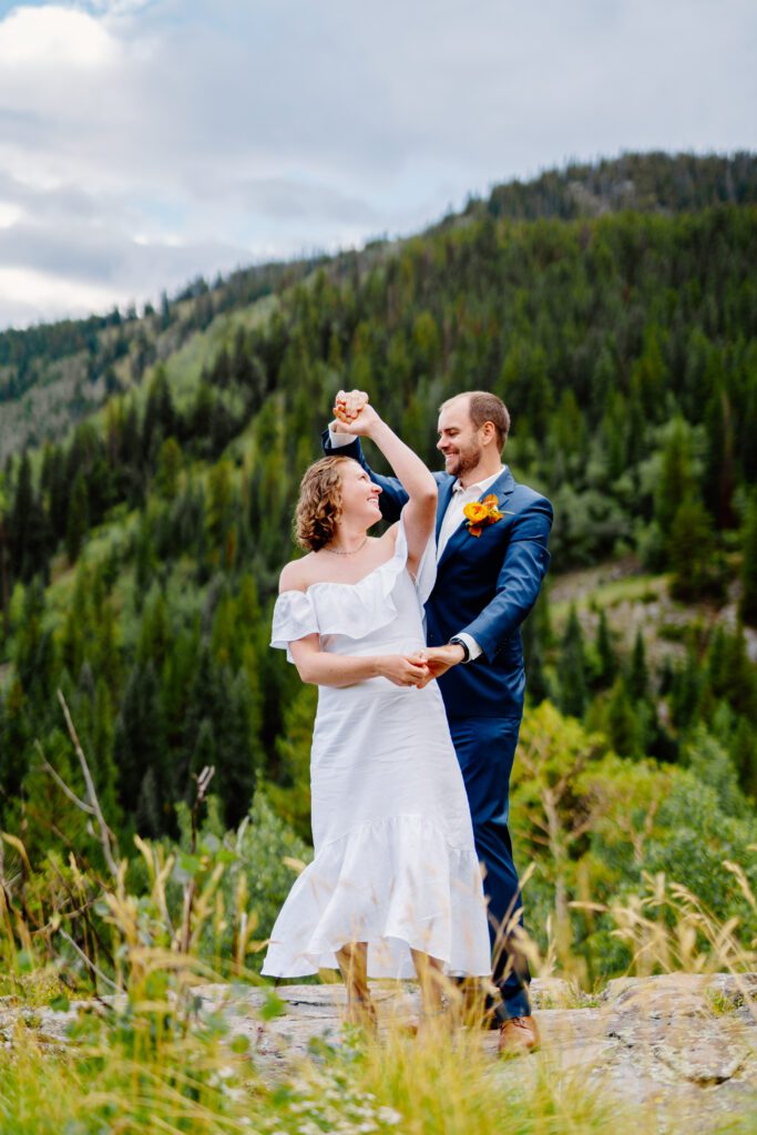 bride and groom sharing their first dance on top of a mountain during their eldora mountain colorado elopement 