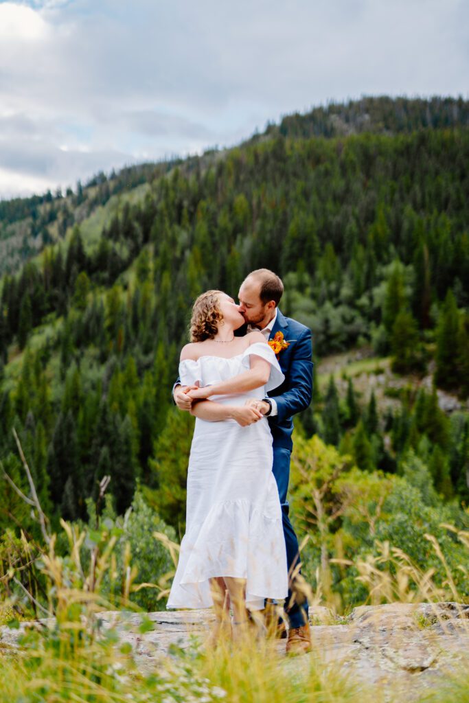 bride and groom kissing after their first dance at their eldora mountain colorado elopement