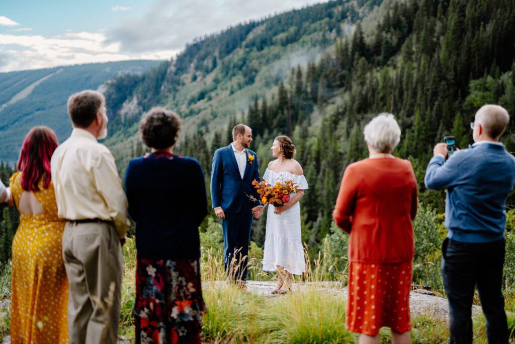 bride and groom looking at each other smiling during their eldora mountain colorado elopement