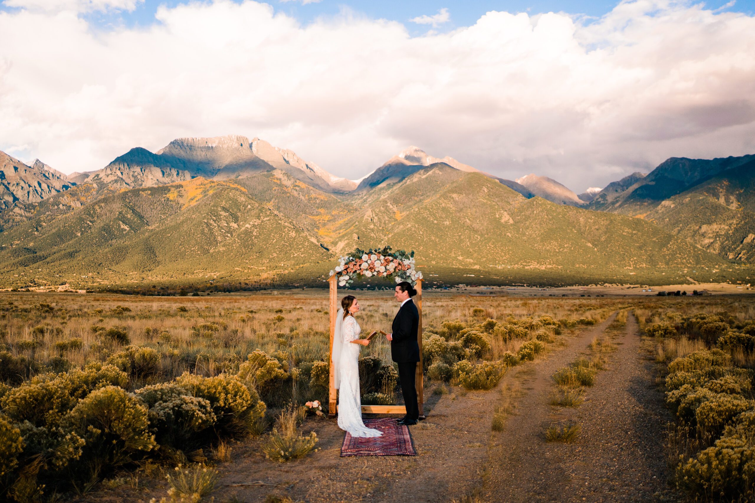 bride and groom standing at the base of the rocky mountains at golden hour during their colorado springs elopement ceremony