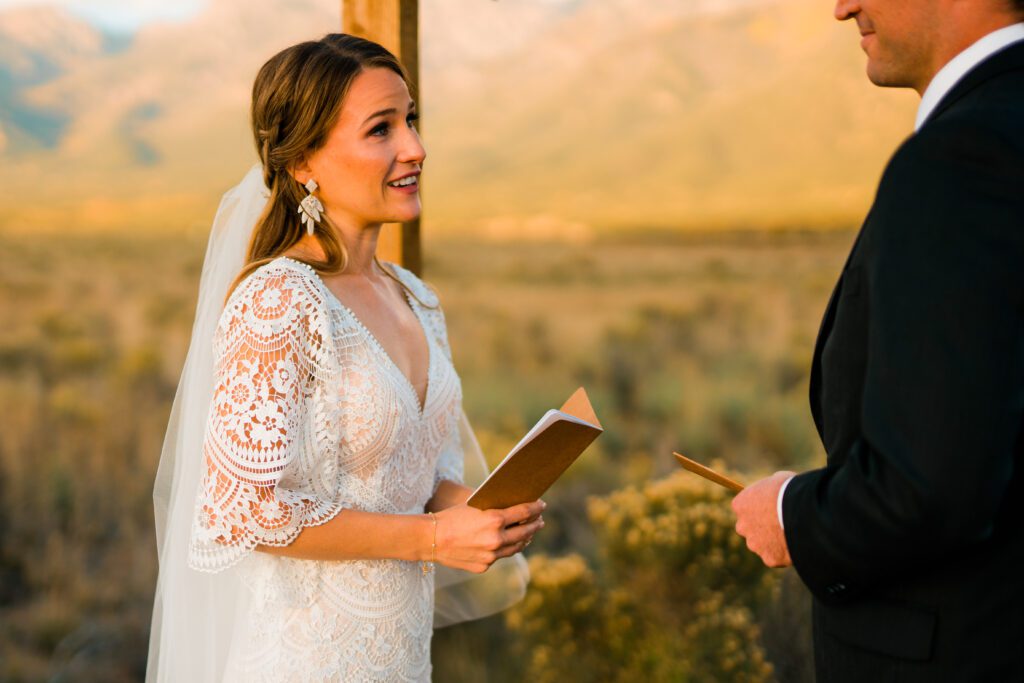 closeup of bride reading her vows to her groom during their colorado springs elopement near crestone colorado