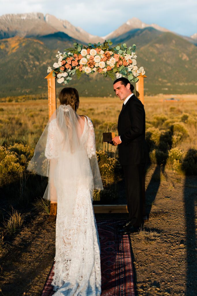 bride walking down the aisle to her groom with the mountains in the background during their colorado springs elopement