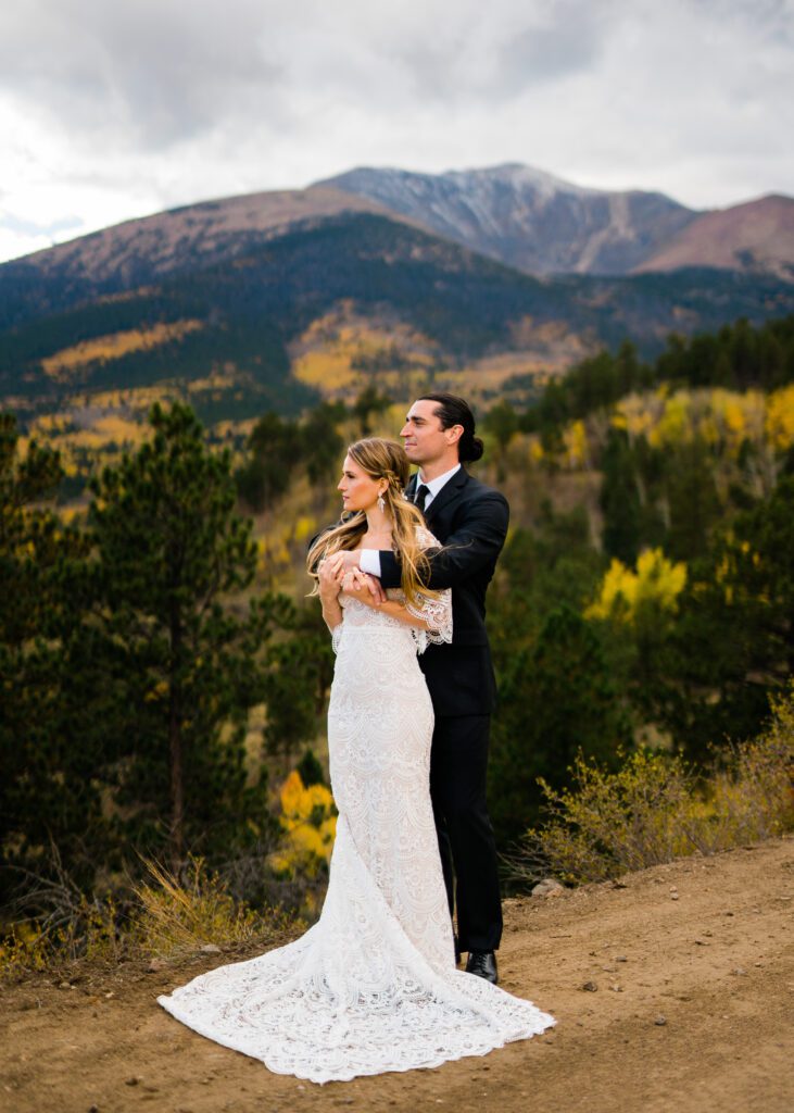 groom and bride looking out at the mountains during their colorado springs elopement near crestone colorado