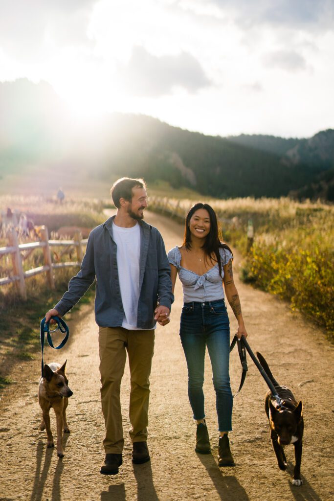 engaged couple walking thier dogs in boulder colorado during their Chautauqua Park Engagement Photos