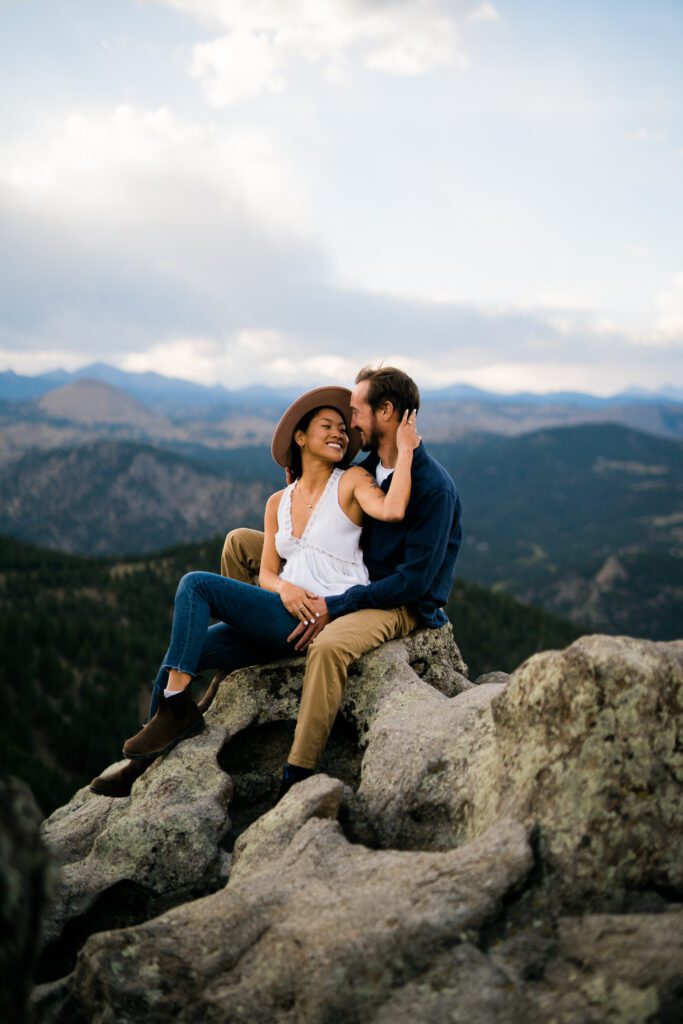engaged couple sitting on a rock at lost gulch in boulder colorado during their Chautauqua Park Engagement Photos