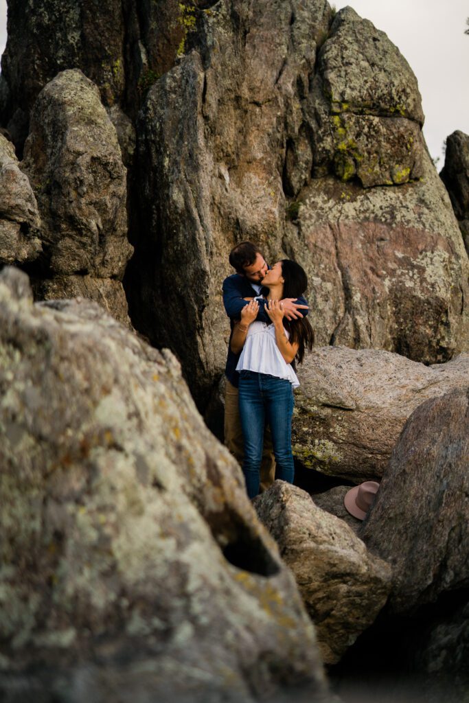 engaged couple standing in a rock formation at lost gulch in boulder colorado during their Chautauqua Park Engagement Photos