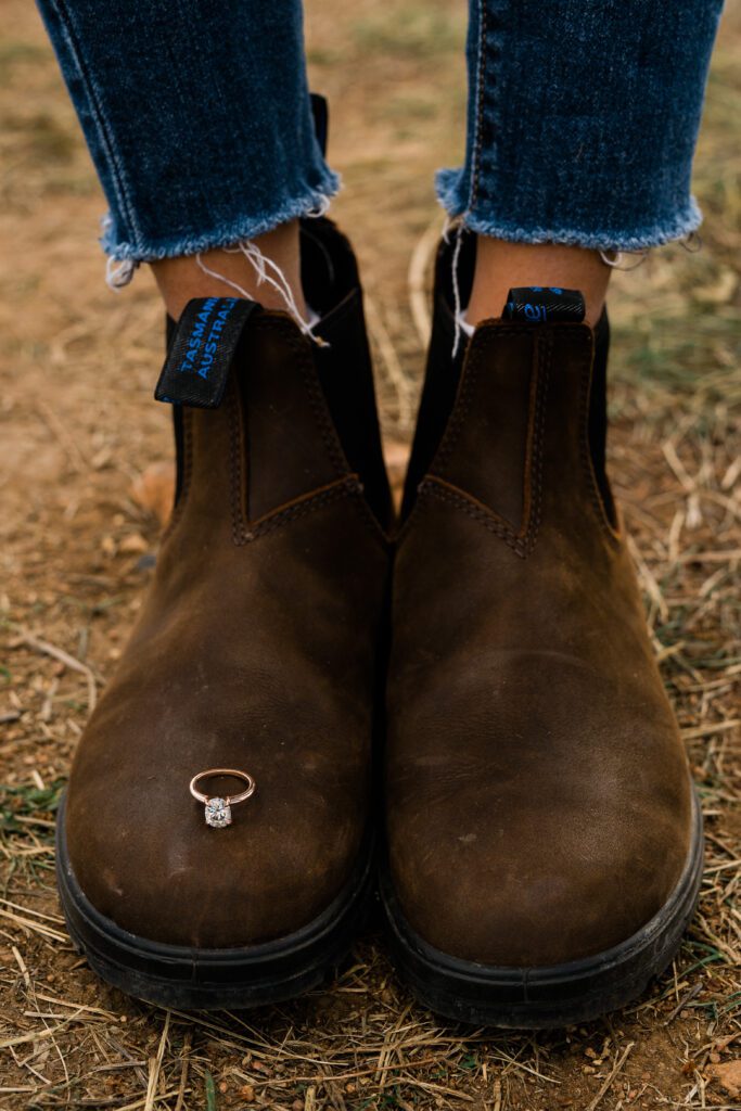 engagement ring sitting on fiancee's blundstones during their Chautauqua Park Engagement Photos