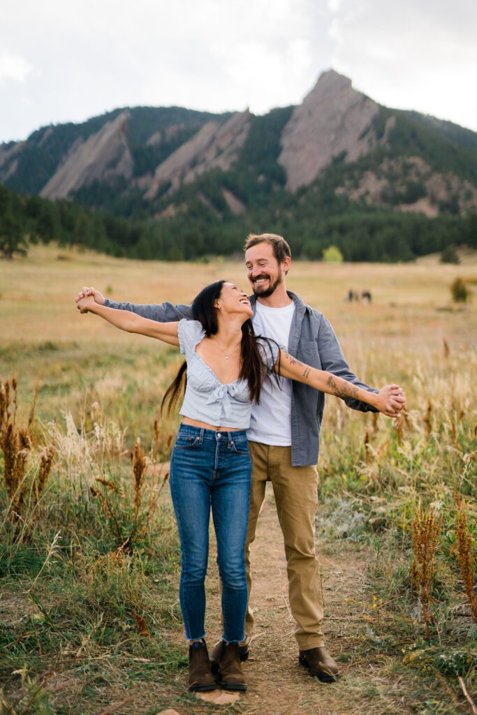 cute engaged couple laughing and having fun at their Chautauqua park engagement photos