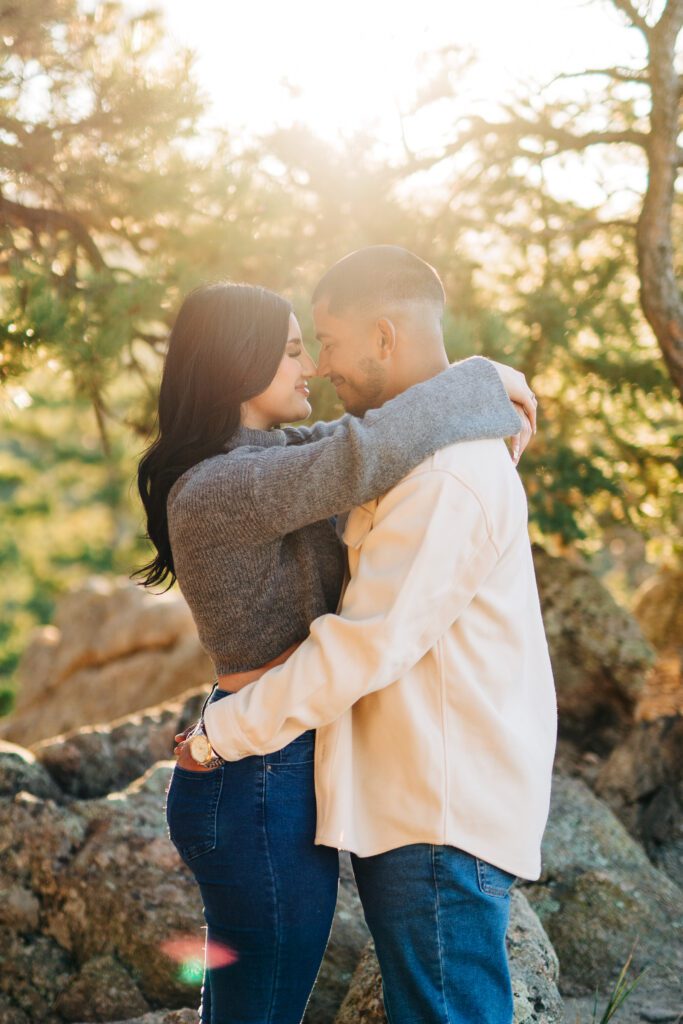 couples standing under the trees at lost gulch overlook in boulder colorado during golden hour for their fall couples session 