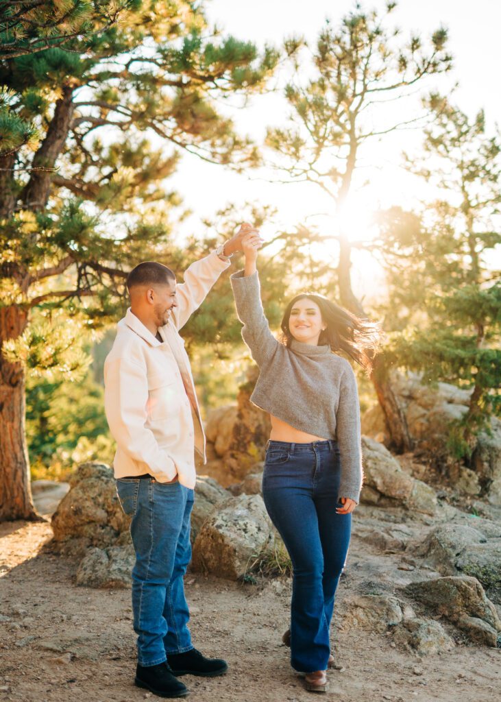 couple dancing under the trees during golden hour at lost gulch overlook in boulder colorado during their couples session