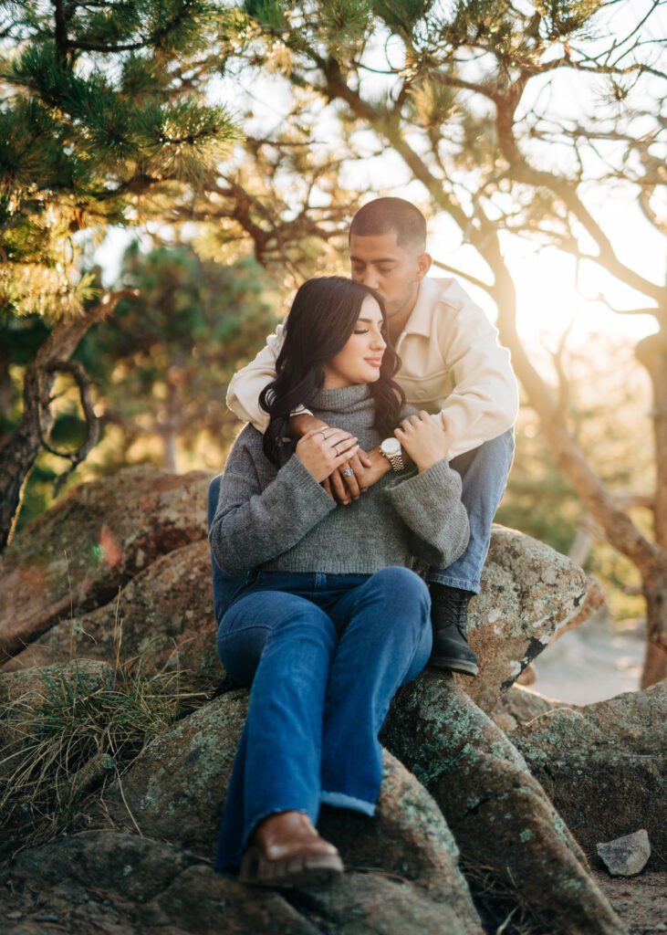 boyfriend kissing his girlfriend on the temple during their couples photoshoot at lost gulch overlook in boulder colorado