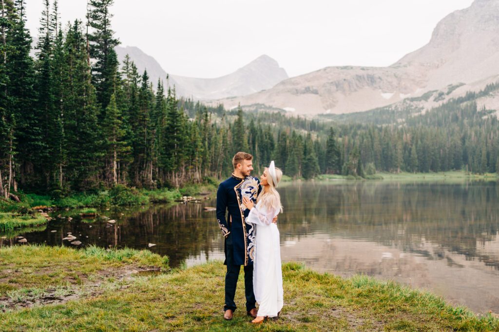 Bride and groom in traditional Vietnamese wedding attire with Lake Mitchell in the background during their Colorado elopement at Brainard Lake Recreation Area