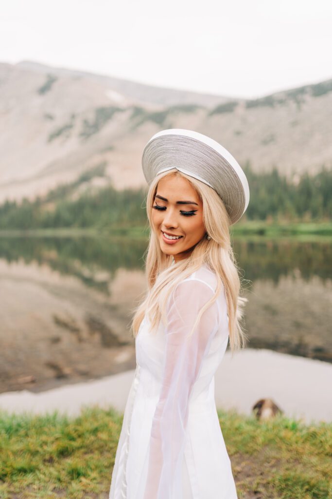 Portrait of Vietnamese bride wearing traditional wedding attire with Lake Mitchell in the background during her Colorado elopement at Brainard Lake Recreation Area