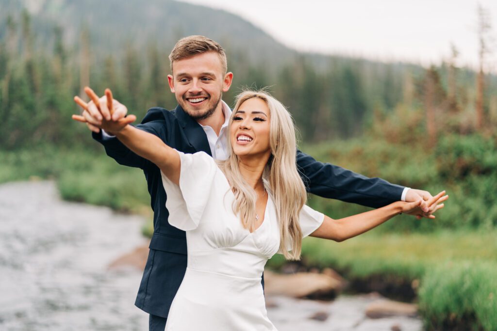 Bride and groom being silly during their elopement photos at Brainard Lake in Colorado
