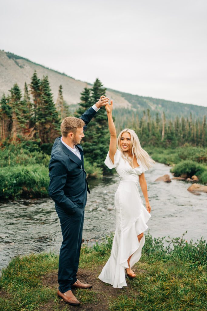 Groom spinning the bride around during their first dance at Lake Mitchell during their Colorado elopement at Brainard Lake Recreation Area